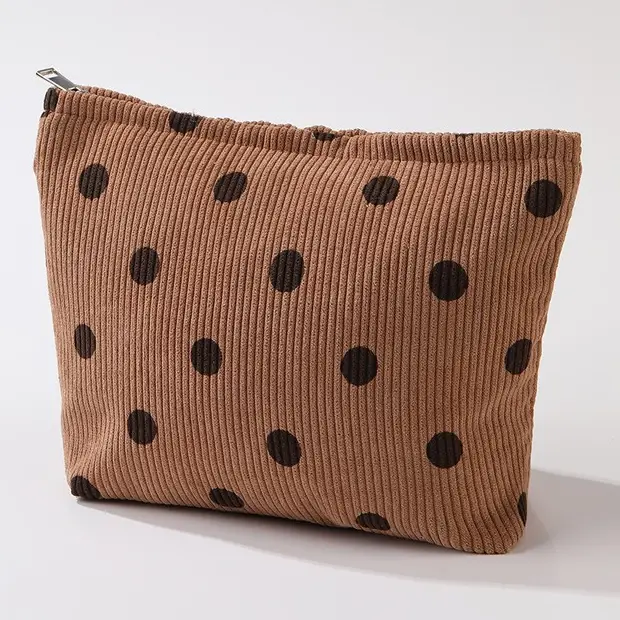 Brown ribbed makeup bag with dark polka dots